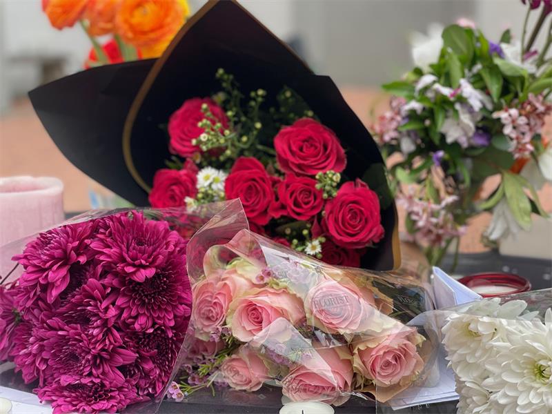Flowers and candles form part of a tribute at Crawford International Sandton College, as learners and staff gather to stand against gender-based violence on September 18, 2026.