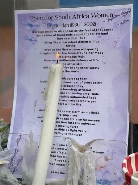 A candle burns in front of a display featuring June Jordan’s Poem for South Africa Women as Crawford College Sandton honours women who have lost their lives to gender-based violence on September 18, 2026.