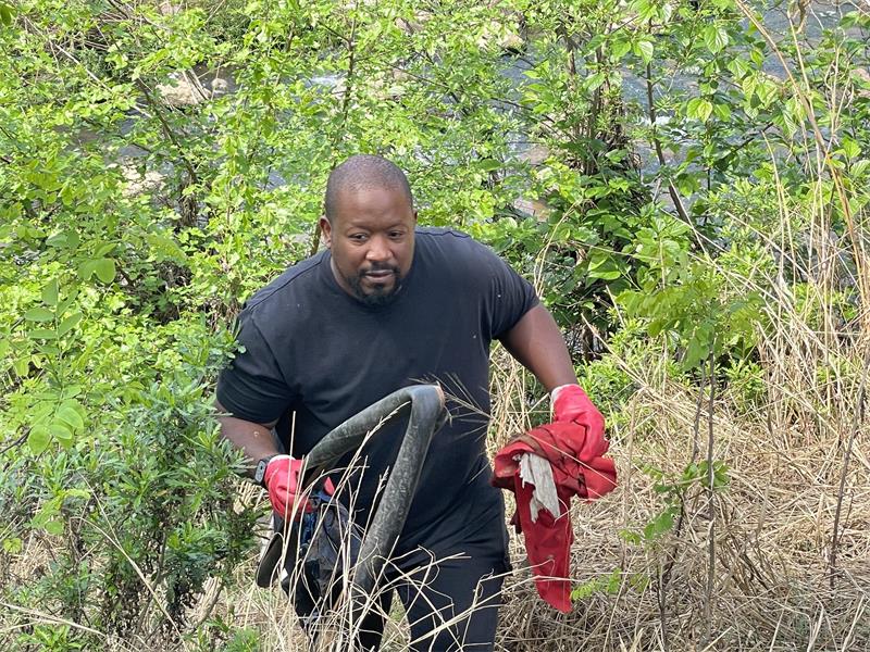 Hlanzekile Rivers and Oceans Cleaning founder Floyd Nyai removes waste from a Braamfontein Spruit riverbank during the World Cleanup Day on September 20, 2026.