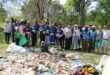 Volunteers from Community Hours and partner organisations gather beside waste collected during a World Cleanup Day clean-up of the Braamfontein Spruit in Bryanston on September 20, 2026.
