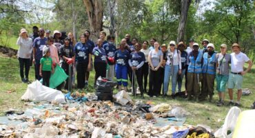 Volunteers from Community Hours and partner organisations gather beside waste collected during a World Cleanup Day clean-up of the Braamfontein Spruit in Bryanston on September 20, 2026.
