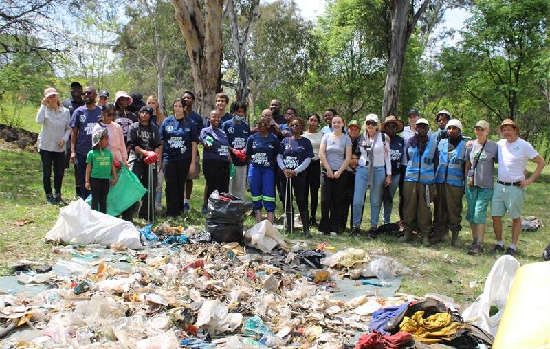 Volunteers from Community Hours and partner organisations gather beside waste collected during a World Cleanup Day clean-up of the Braamfontein Spruit in Bryanston on September 20, 2026.