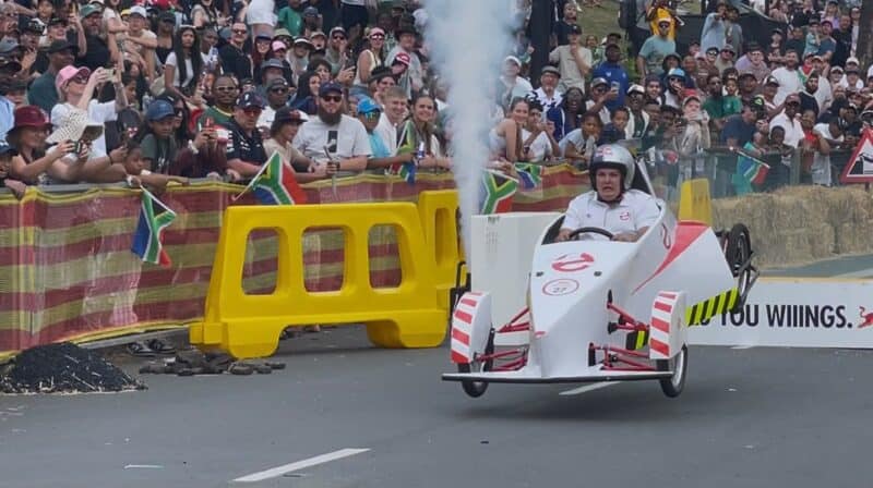 Spectators flock to the sidelines as 57 homemade carts take on jumps, obstacles, and sharp turns in a display of gravity-powered creativity.