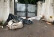 A homeless man lies under tarpaulins and plastic sheeting outside a property on Bombas Road as rain falls on September 30, 2026. Photo: Xoliswa Zakwe