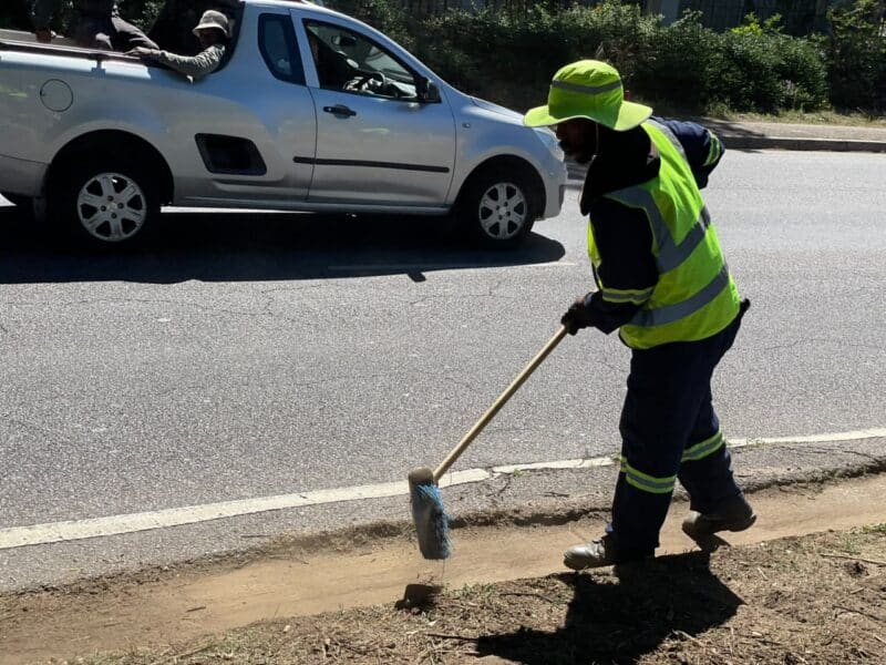 Michael Nku sweeps along the roadside during the Better Bryanston clean up on October 23, 2026.