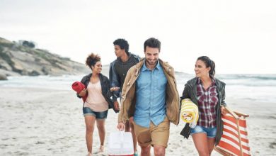 Shot of a group of young friends walking together along the beach