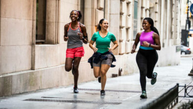 Group of women running through urban area