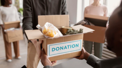 volunteer-collecting-donation-box-from-another-volunteer_23-2149230544