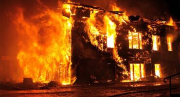 A large fire is burning in a building.