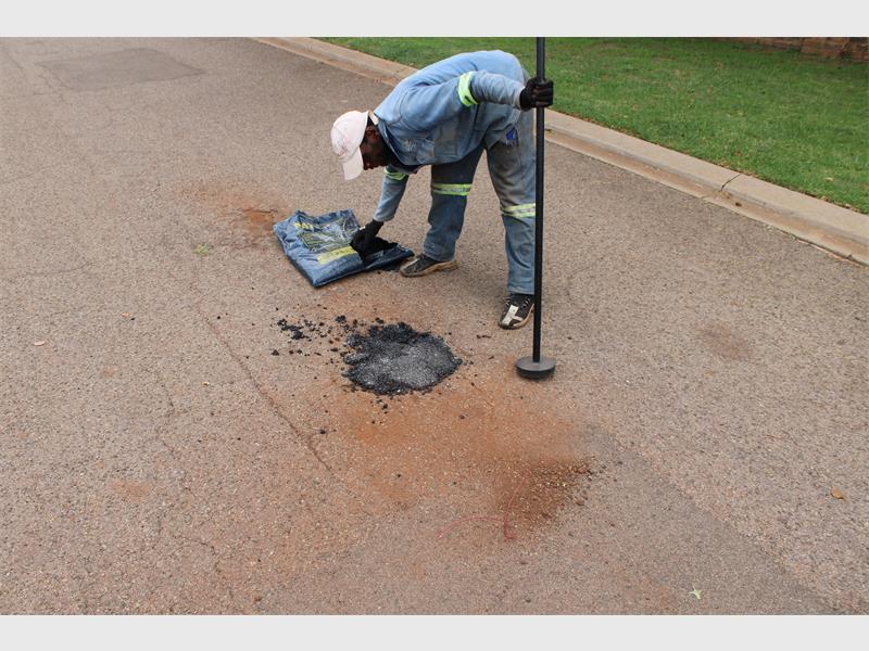 Frustrated by delays, locals pool resources to fix damaged roads and inspire community action.