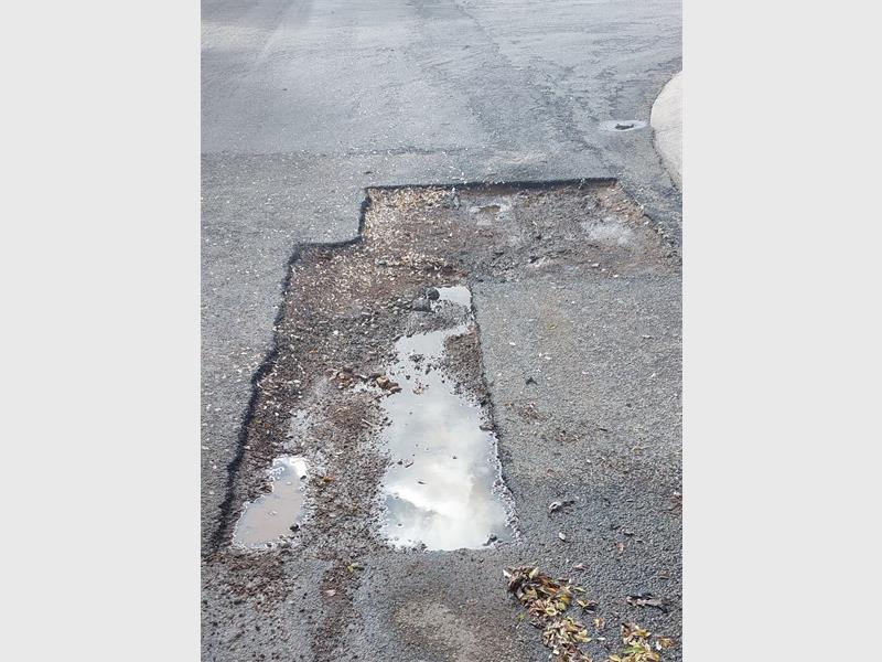 Frustrated residents in Brackenhurst say years of complaints over hazardous potholes and poor street lighting on Koedoe Street have gone unresolved, with motorists suffering vehicle damage and one delivery rider hospitalised after a crash.
