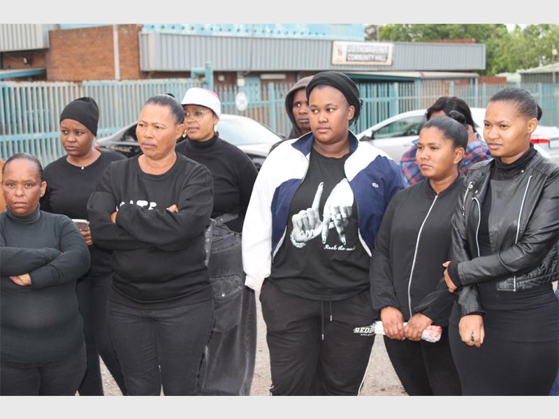Residents gathered outside JD Thomas Hall to honour those affected by gender-based violence and call for stronger community action against abuse and femicide.