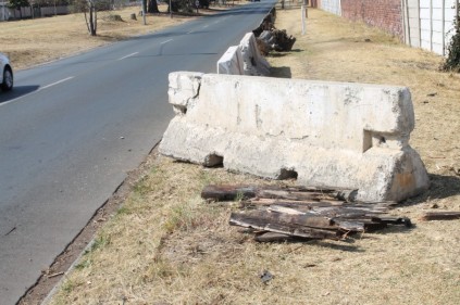 SHATTERED: The concrete and steel barrier was crushed to the side of the road.