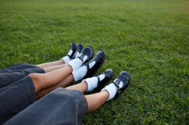 Closeup of legs of 3 schoolgirls in uniforms