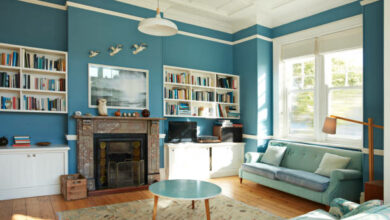 Bookshelf and fireplace in decorated living room at home