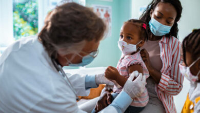 Close up of a mother taking her daughter to the pediatrician to get vaccinated
