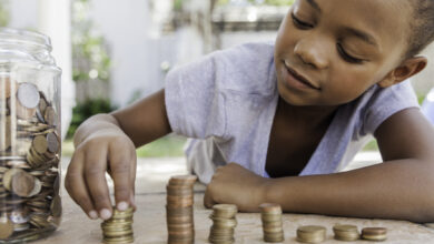 Young girl counting her coins.