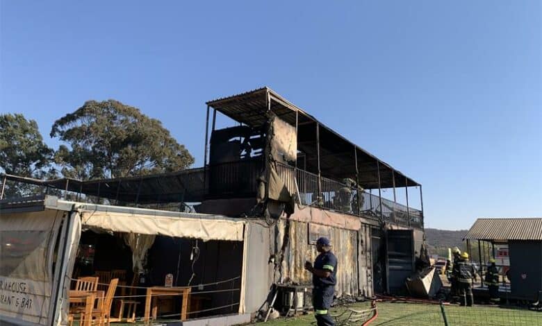 Firefighters from multiple stations battled the Tuesday morning inferno, safely removing gas cylinders as thick smoke forced a nearby road closure.