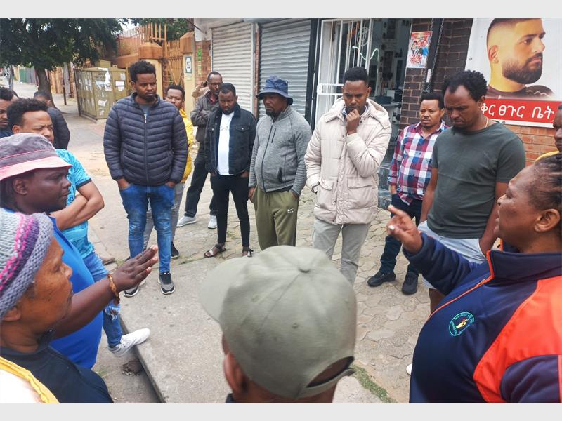 Residents and officials act against congestion, illegal trading, and safety hazards on the 800m street, demanding order and bylaw compliance.