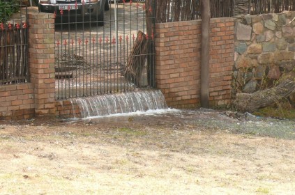 Water flows into the Pereira's neighbours garden.