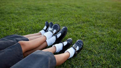 Closeup of legs of 3 schoolgirls in uniforms