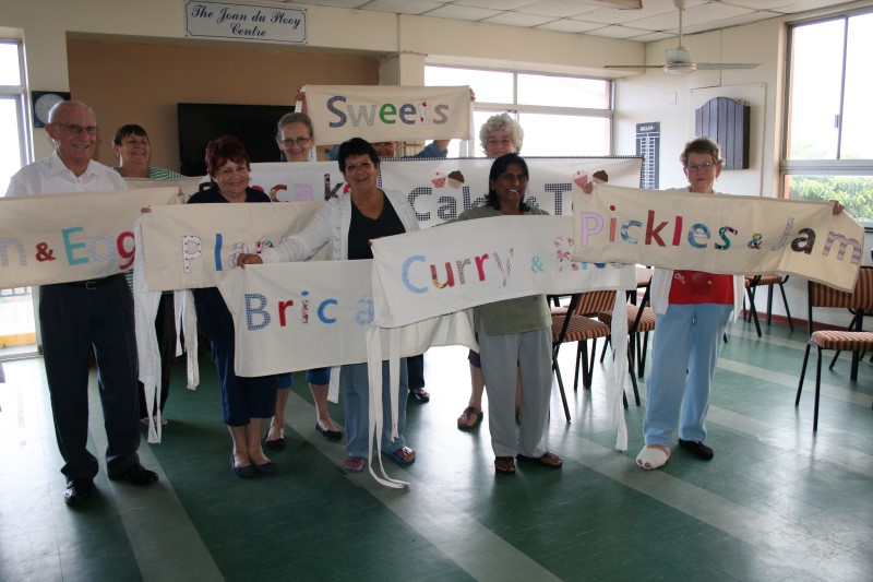 Jabulani Home for the Aged residents show off their colourful banners which will display various tables at their fete on Saturday, 7 June.