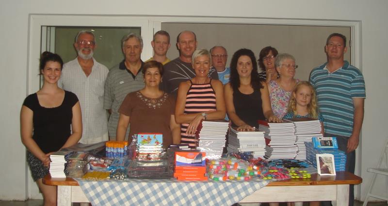 Members of the Kingsway Church International home cell group with stationery packs they donated to KwaMakhutha Comprehensive High School.