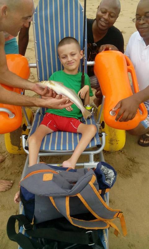 Wesley Smith, Sobantu Ngidi and Sandile Sikhakhane present Reece Smith with his banana fish that won him catch of the day.