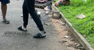 a braai stand with meat on the side of the road