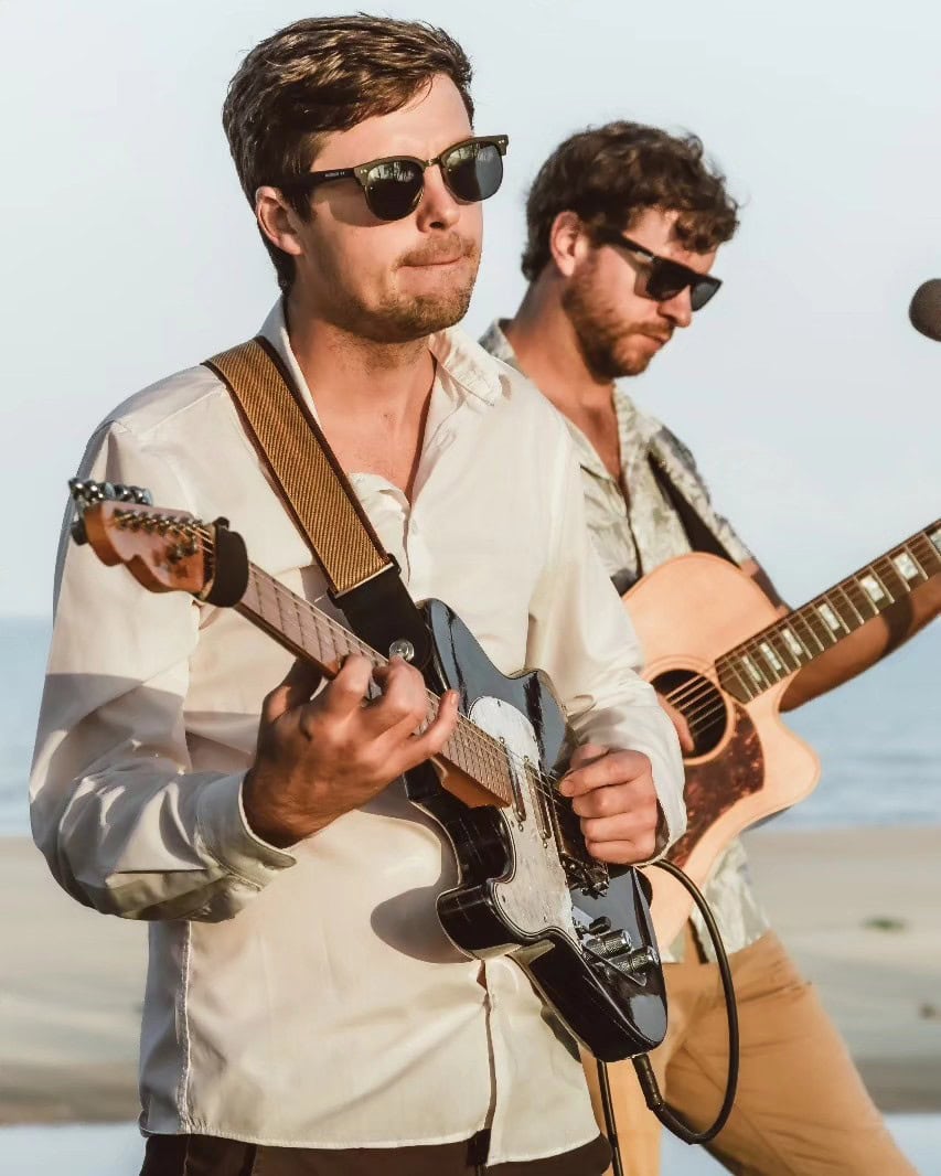 Two musicians playing guitar