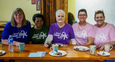 A group of cancer patients in a support group meeting