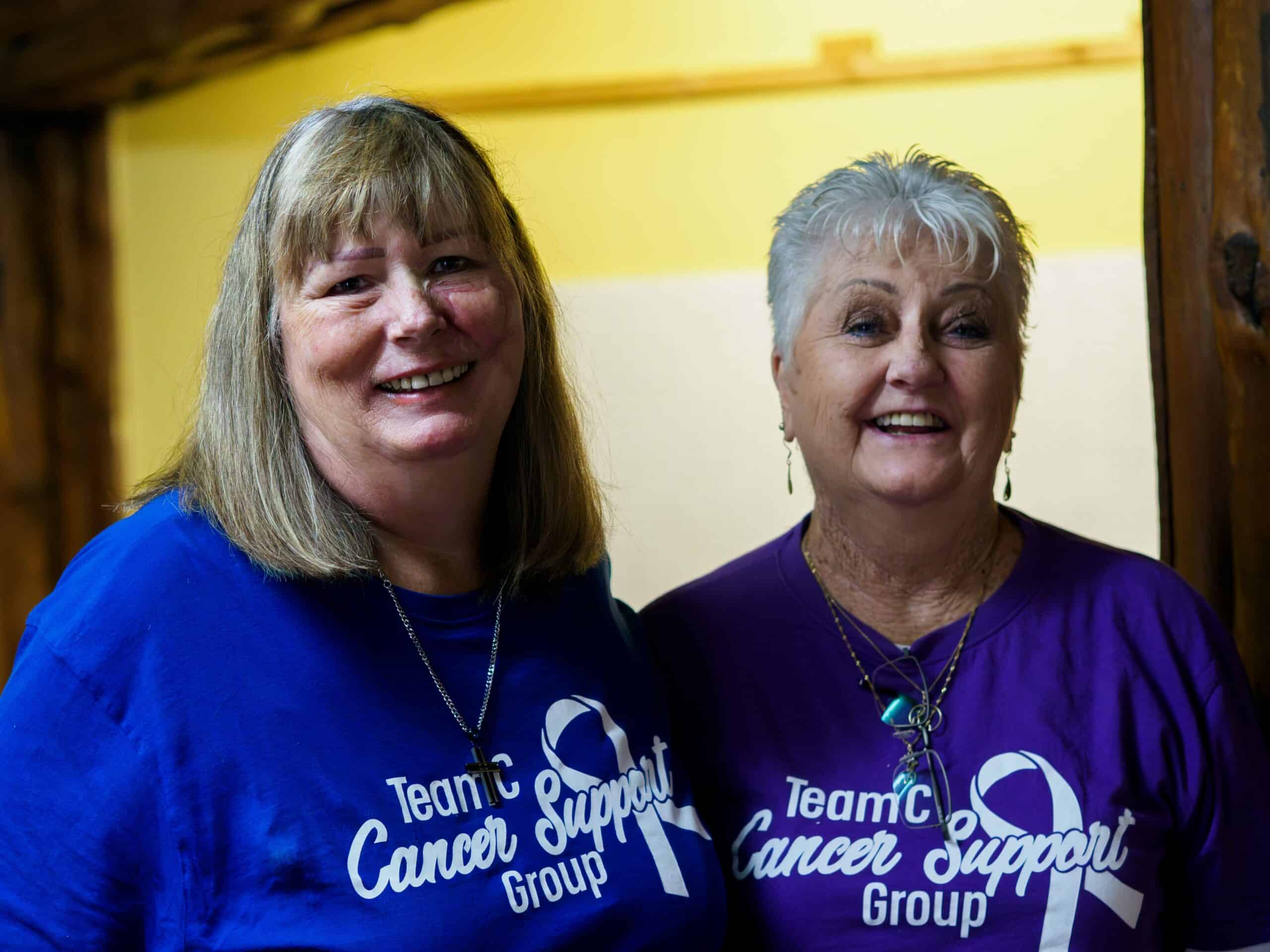Two women pose for a photograph.