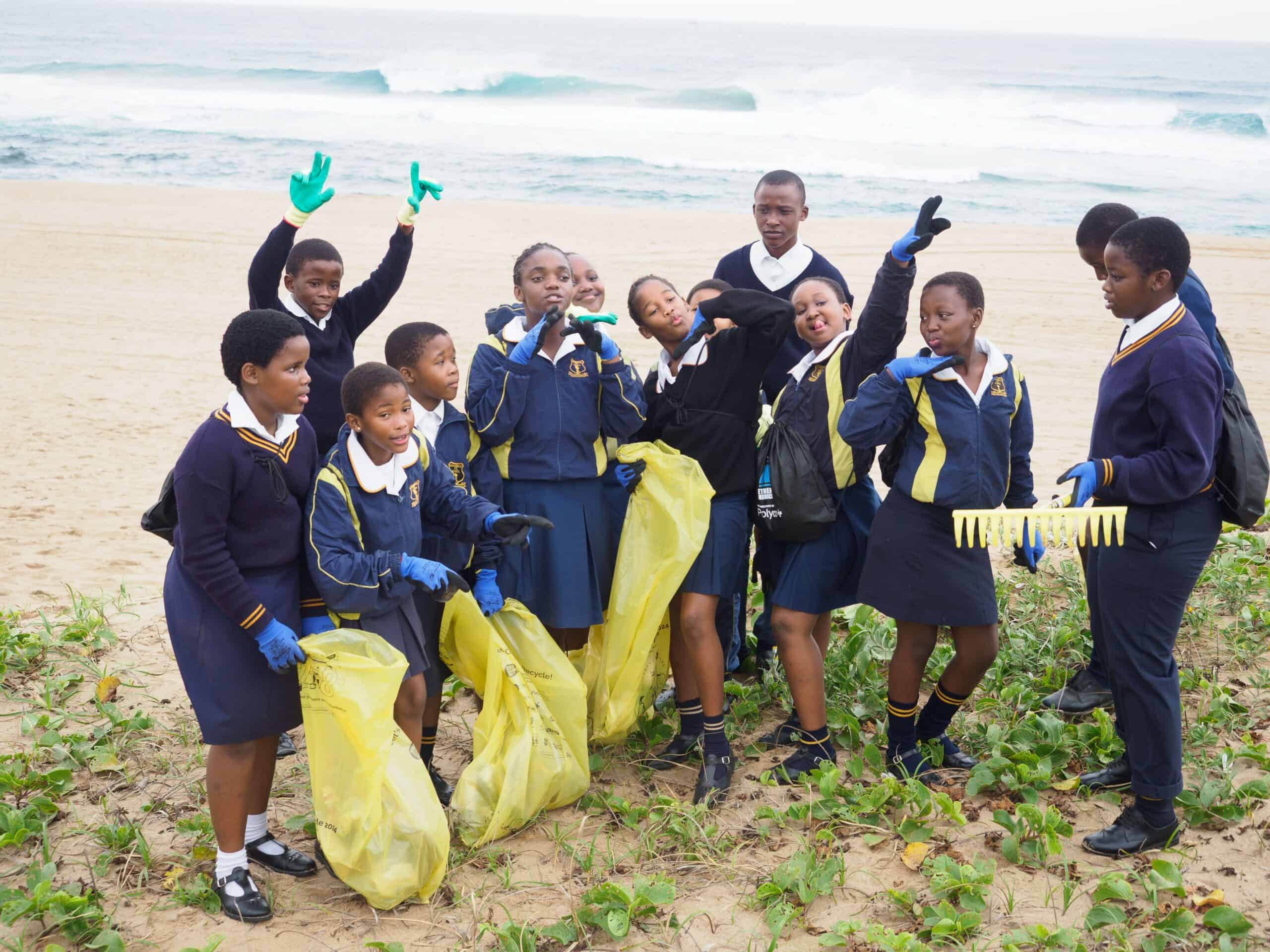 School learners having fun during a beach clean-up.