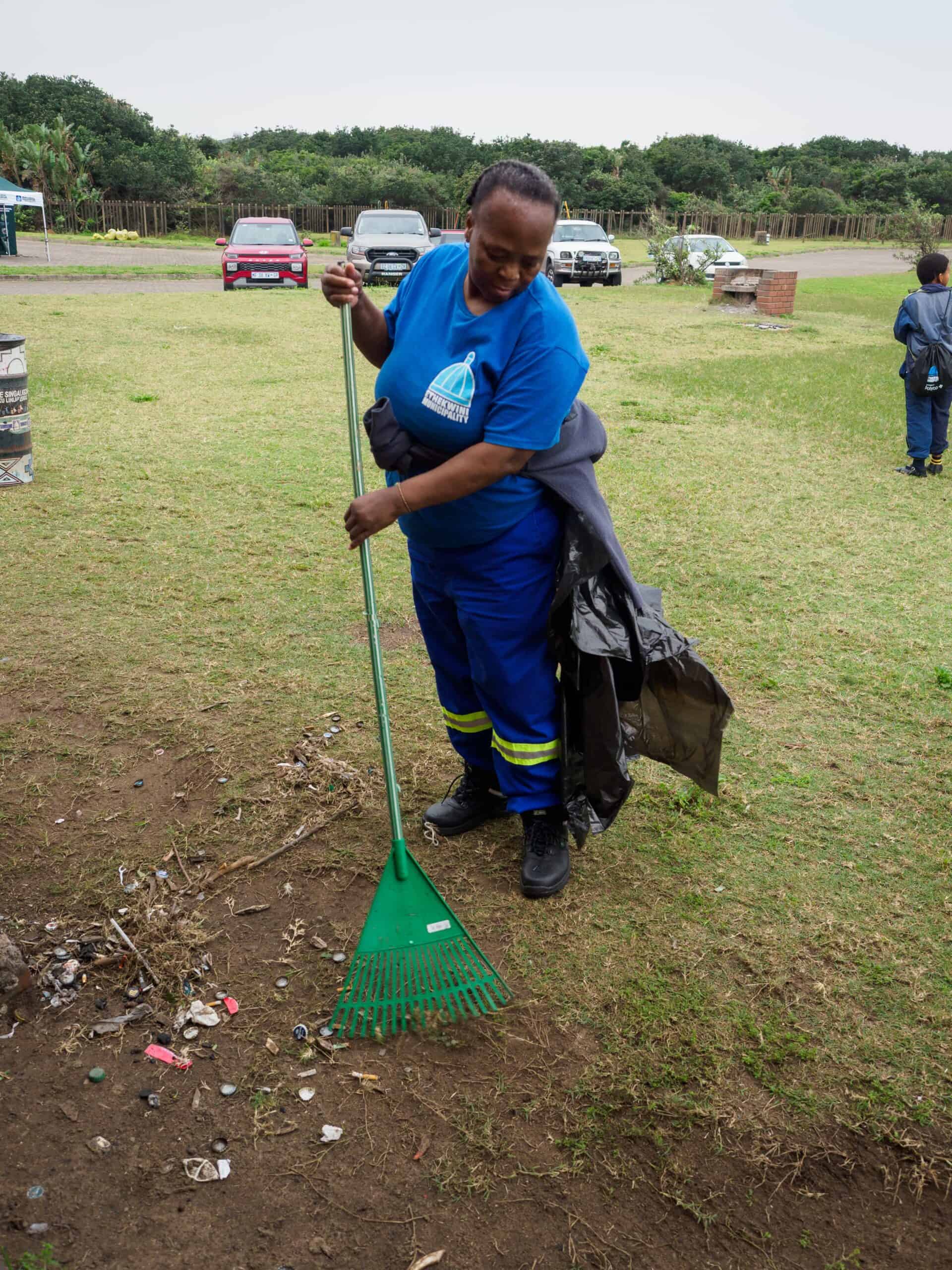 A woman cleaning up a park.