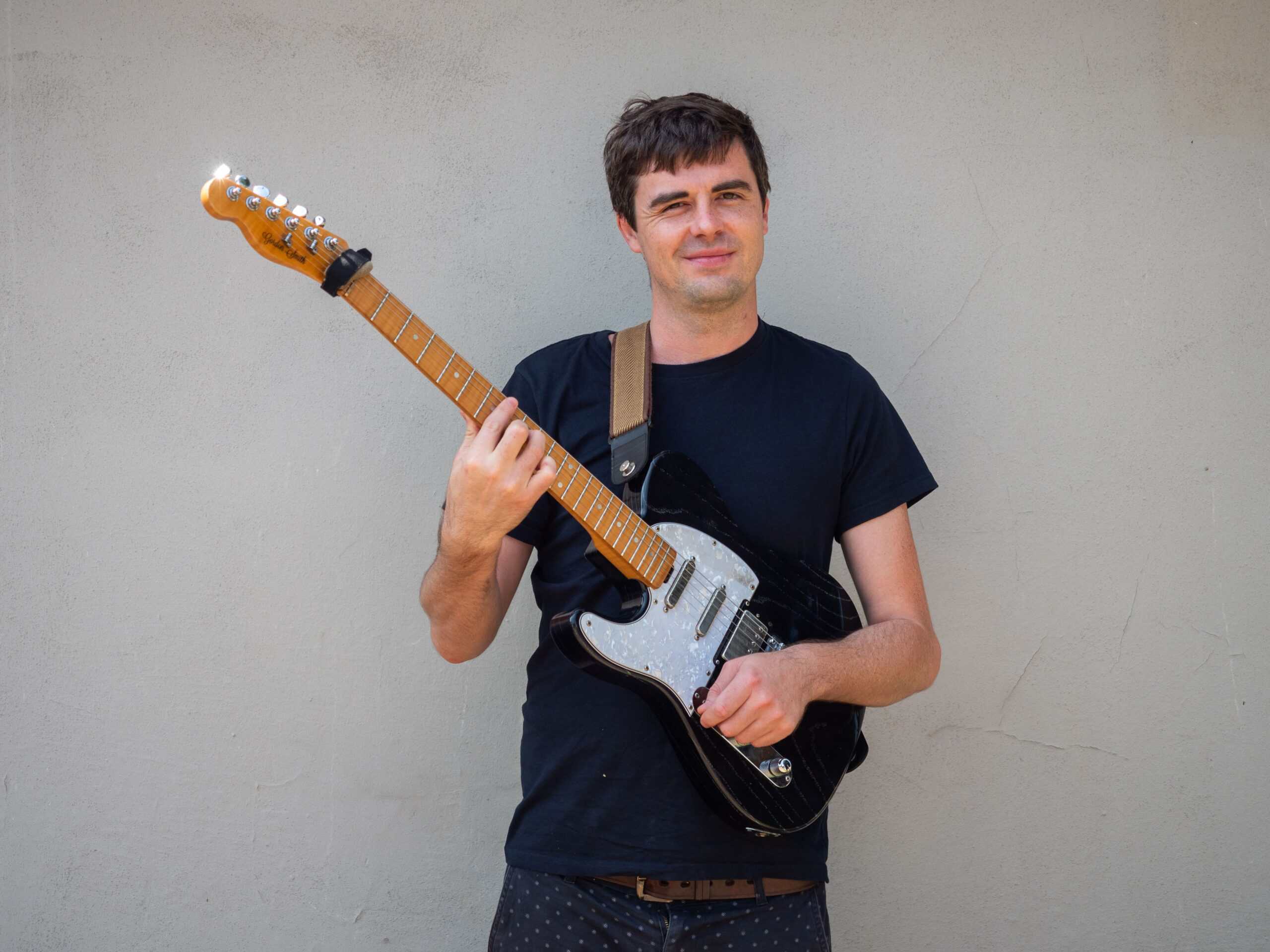 A guitarist strums a tune.