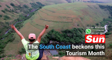 A women holding her arms out, admiring a beautiful view.