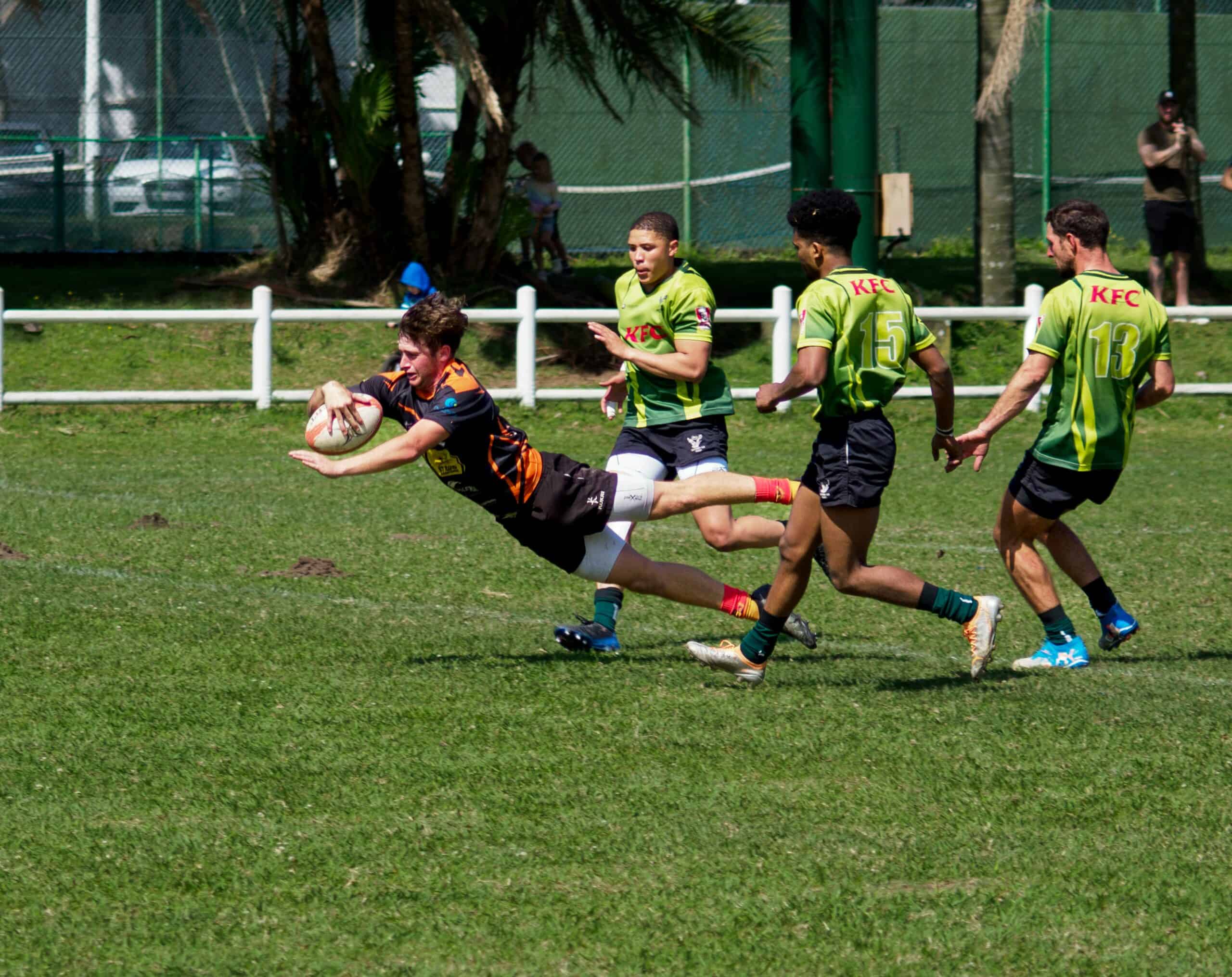 A rugby player jumping forward.