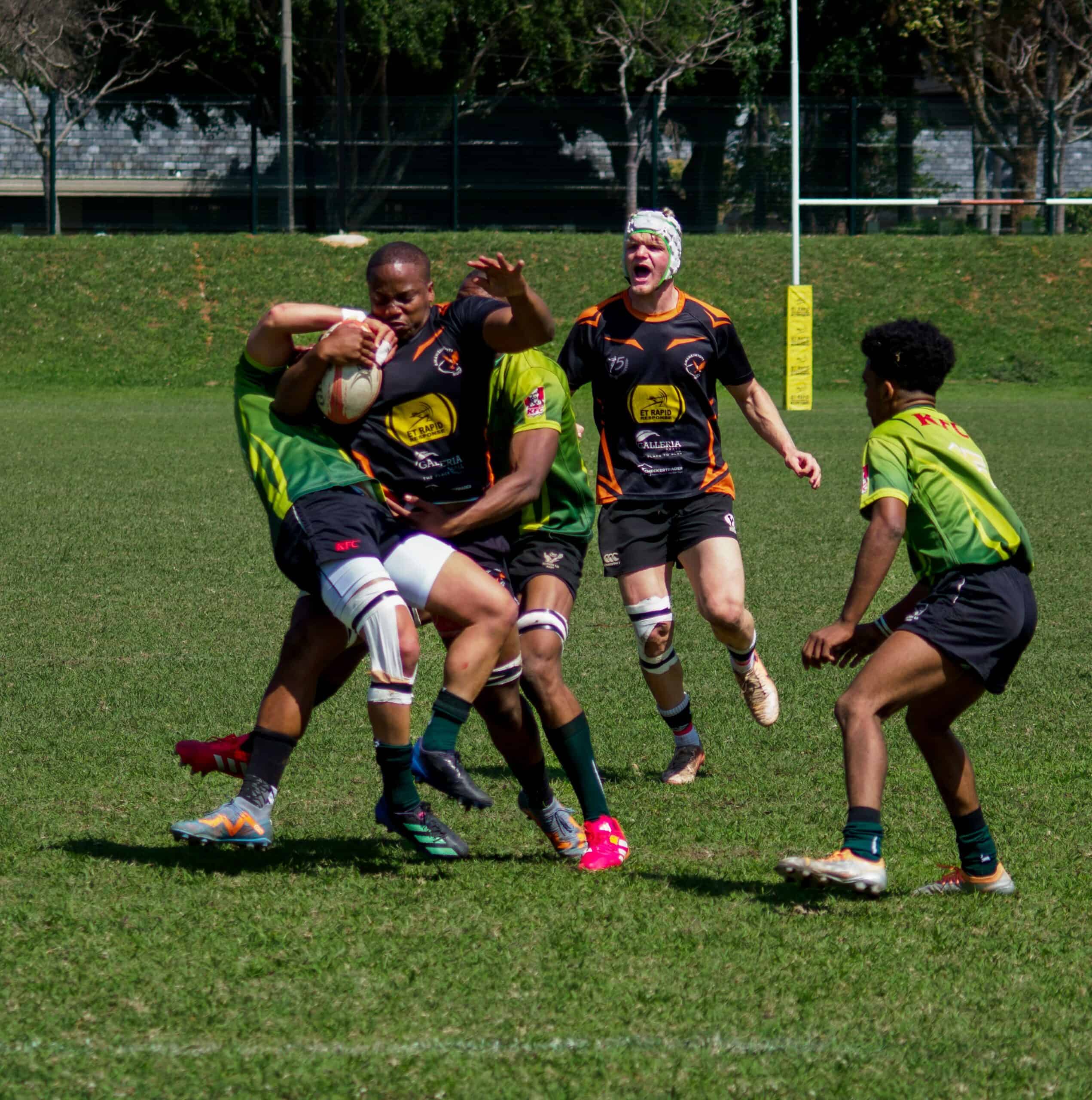 A rugby player getting tackled.