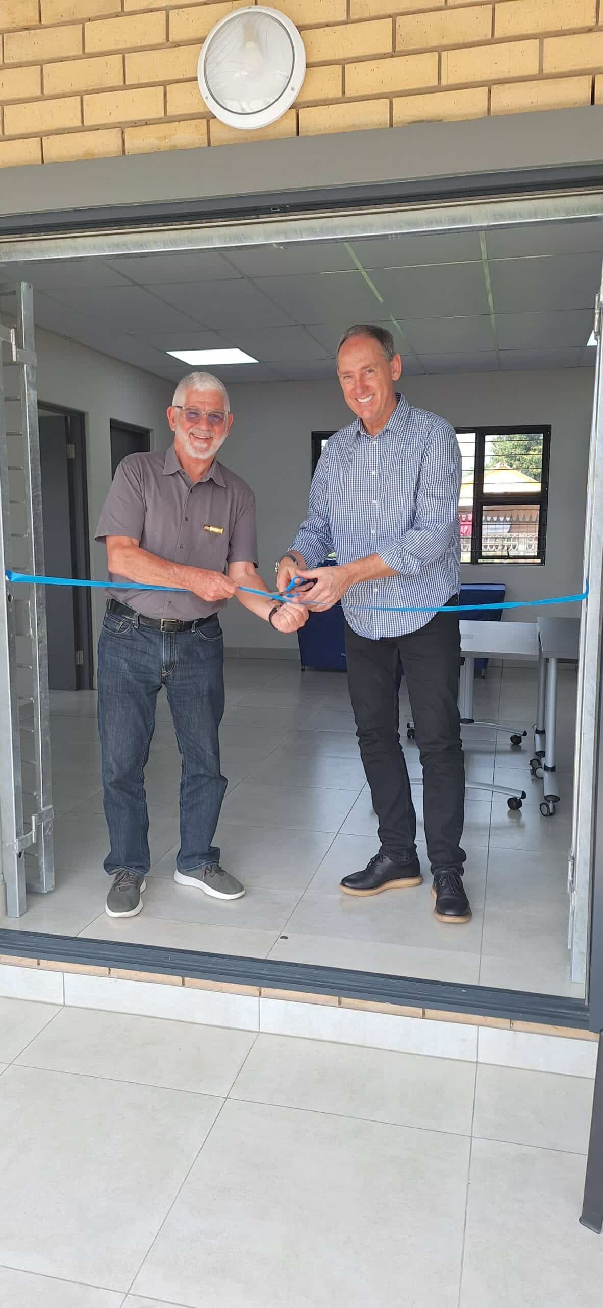 Two men cutting a ribbon.