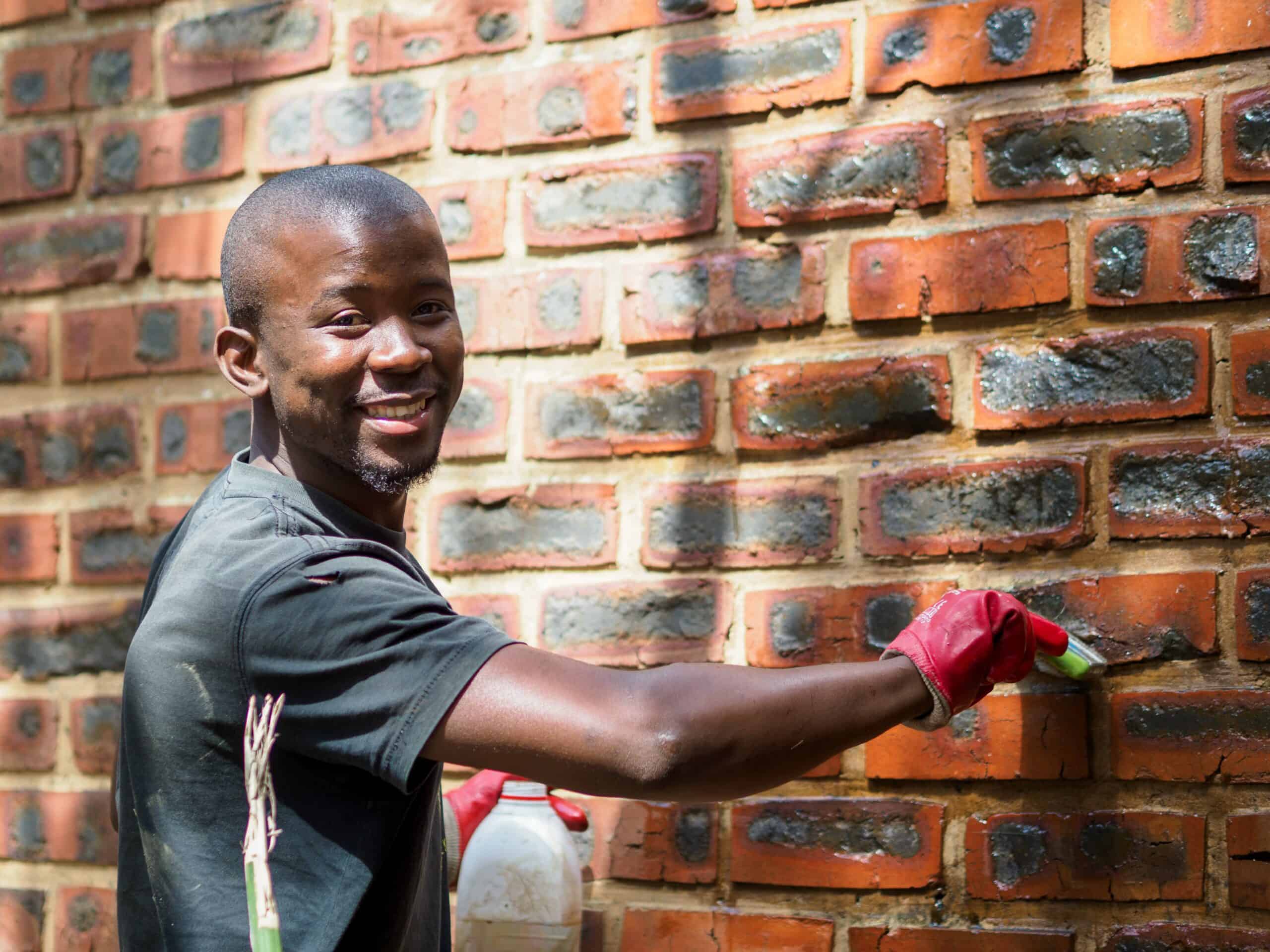A man applying varnish to a wall.