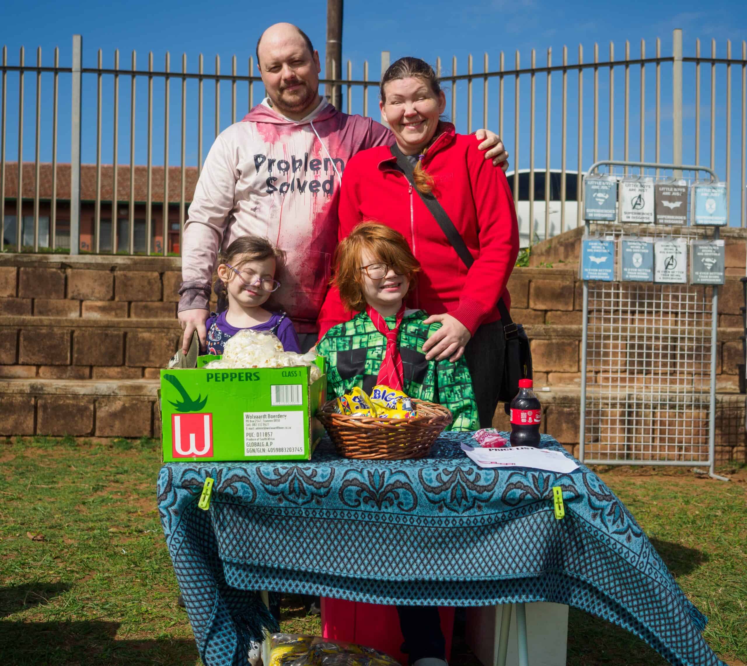 A family poses behind their market stall.