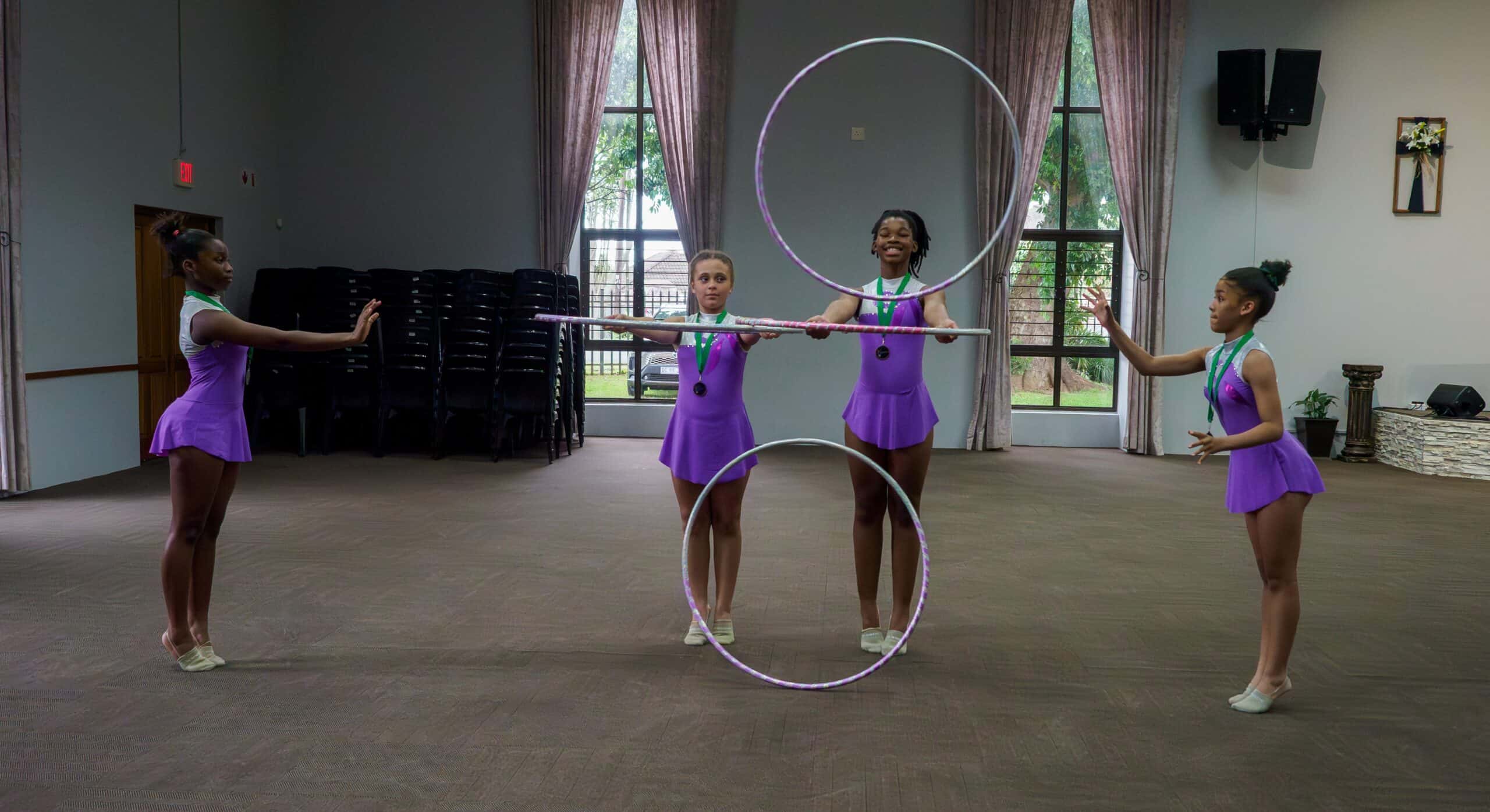 Gymnasts using hoops for a routine.