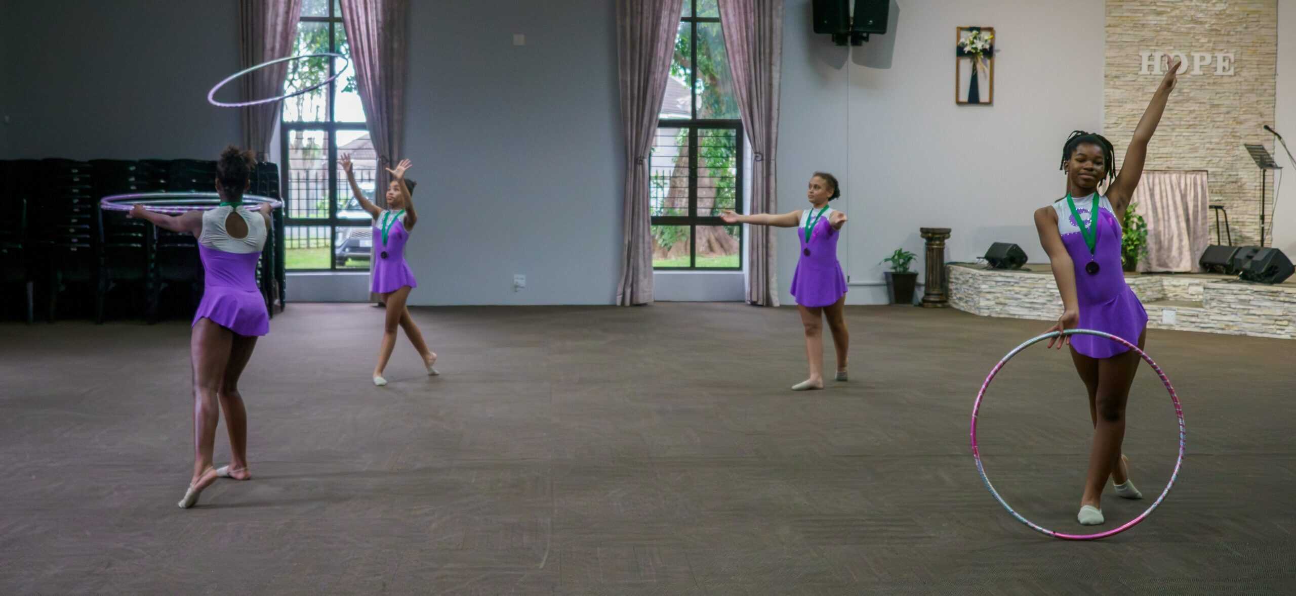 Gymnasts using hoops for a routine.