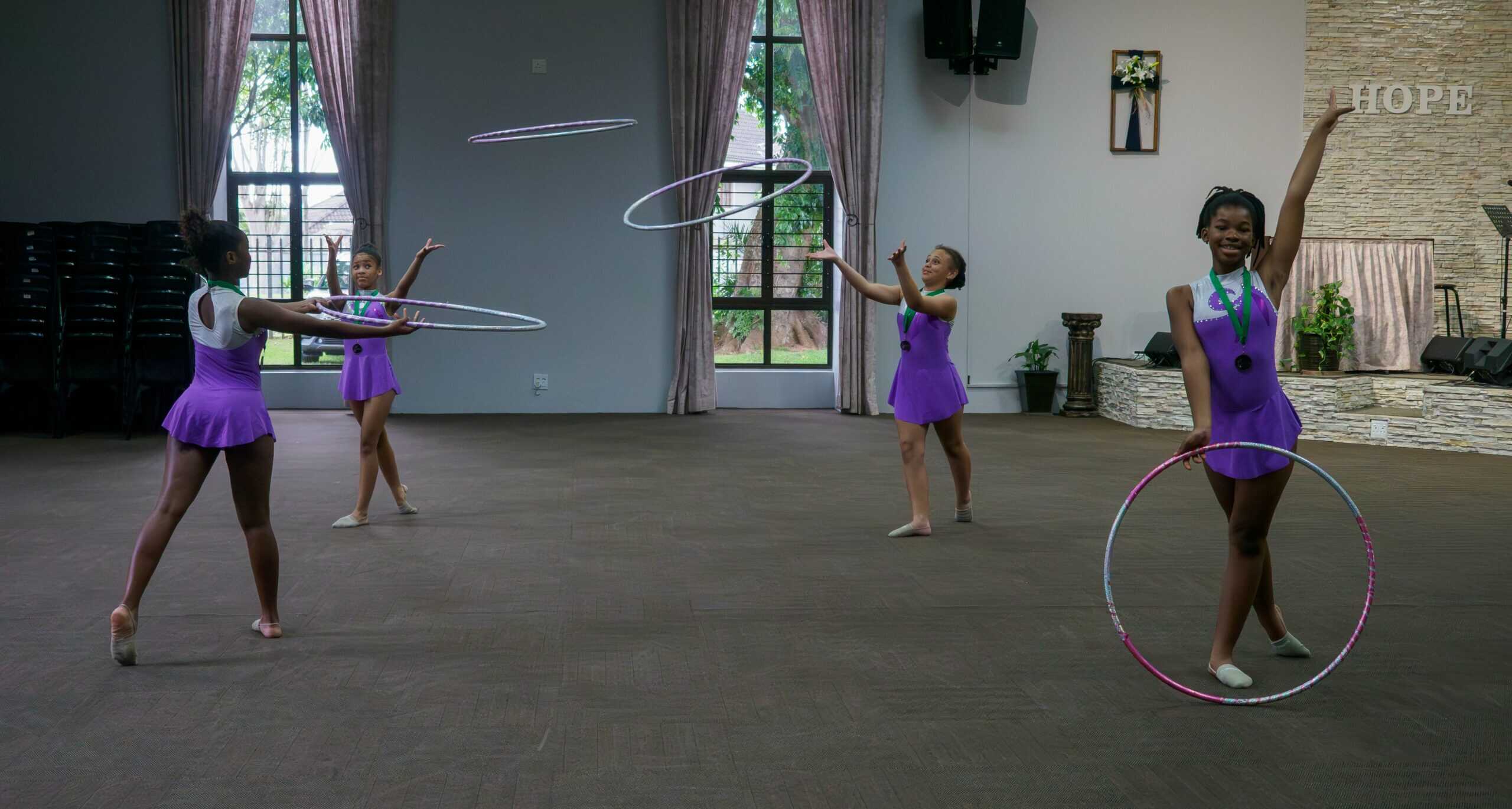 Gymnasts using hoops for a routine.