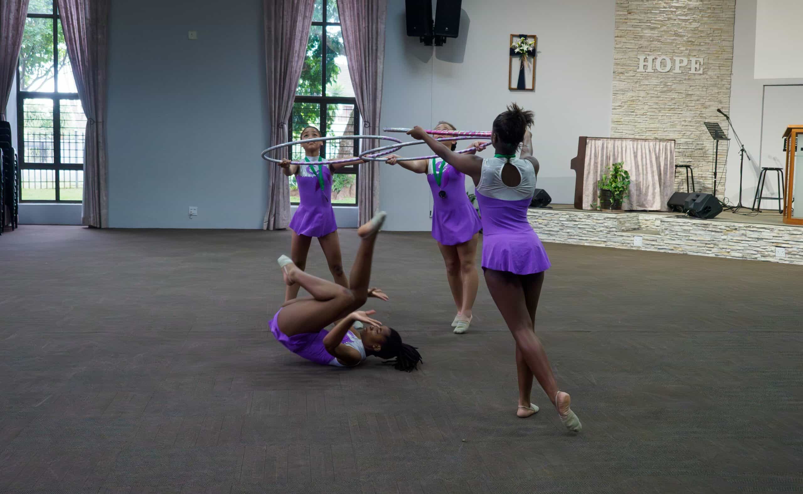 Gymnasts using hoops for a routine.