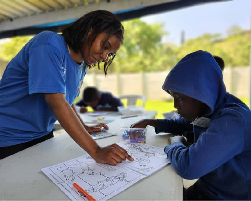 A woman teaching a small child.