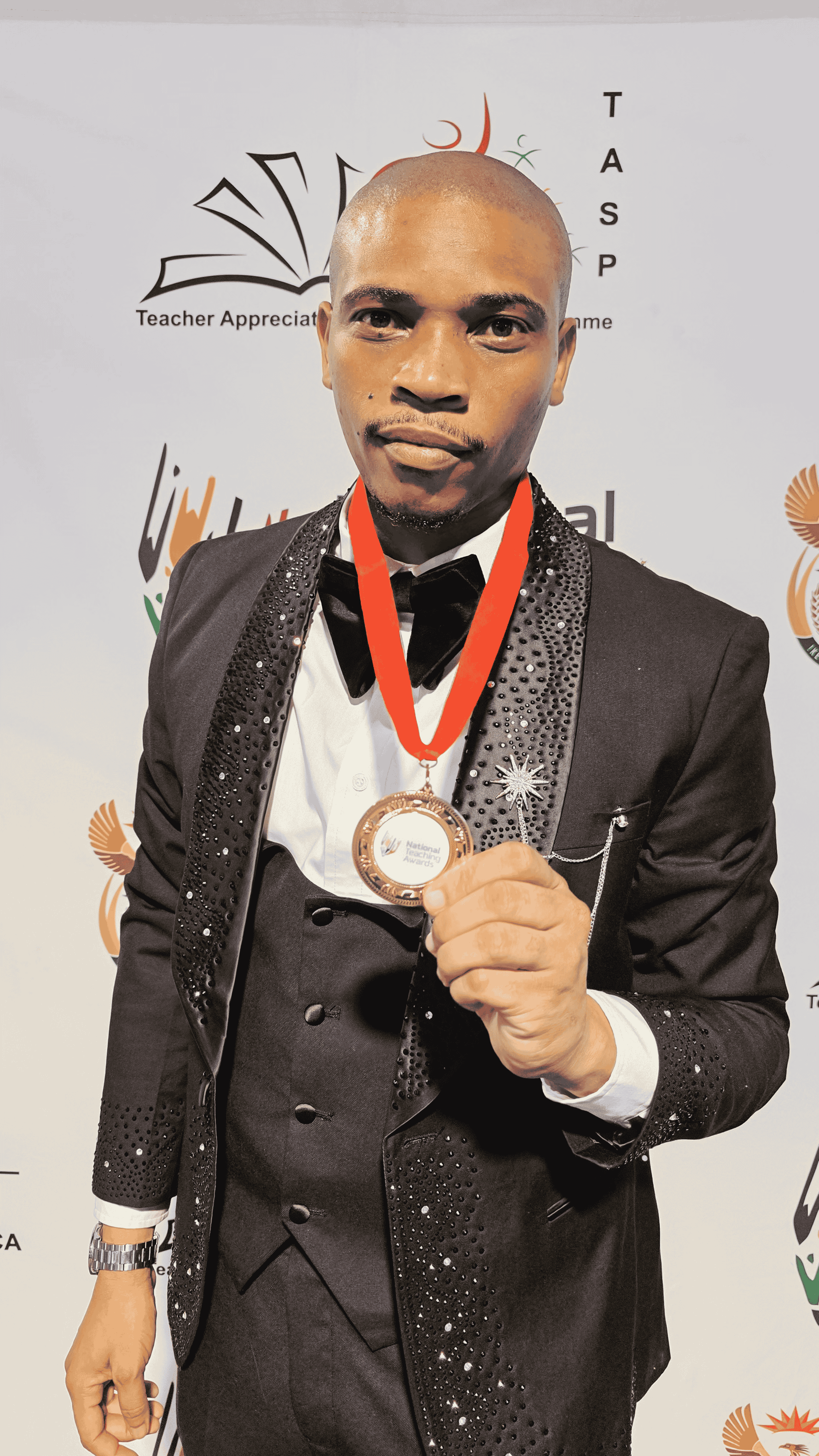 A man holding a medal.