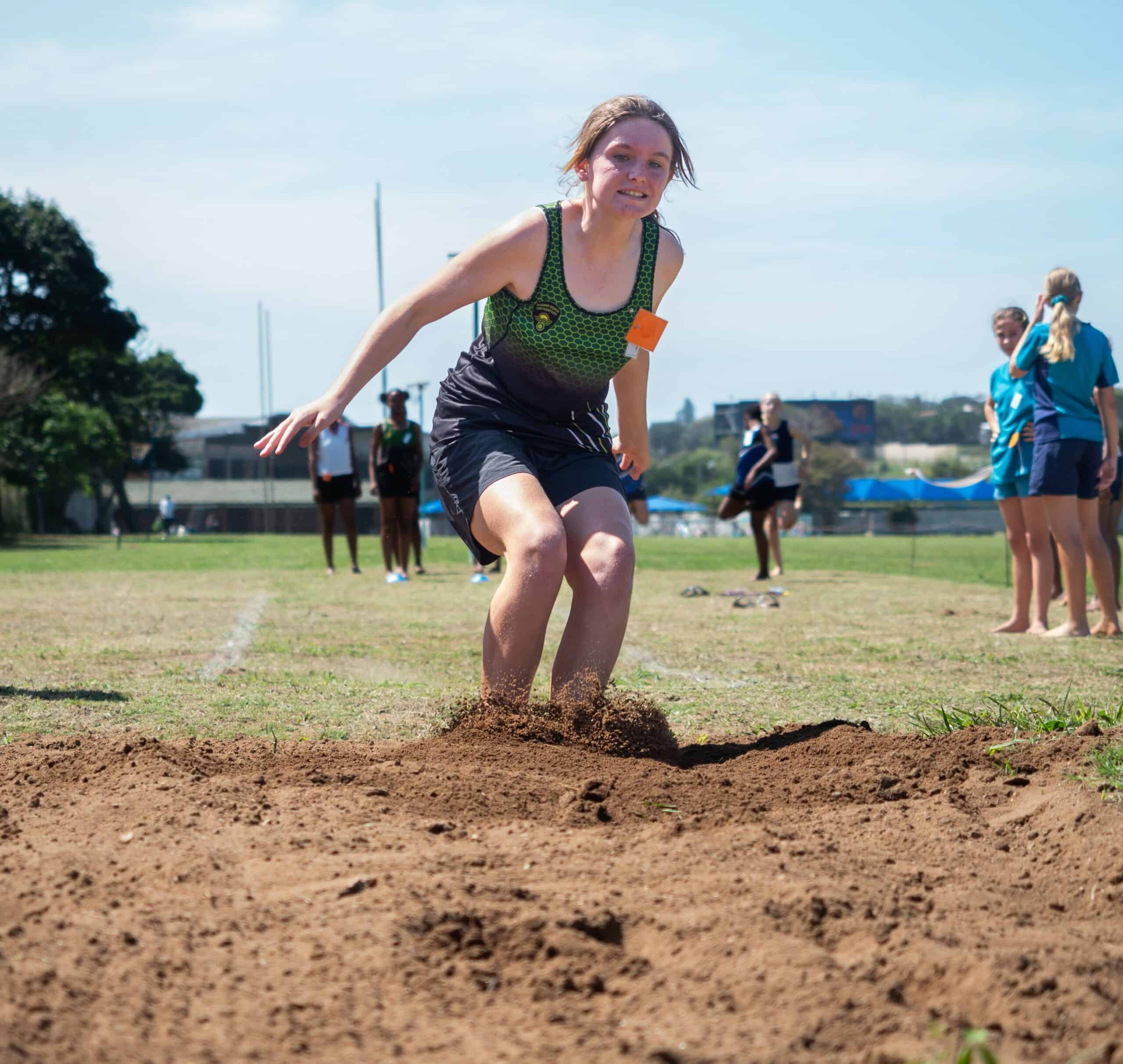 A child doing long jump.