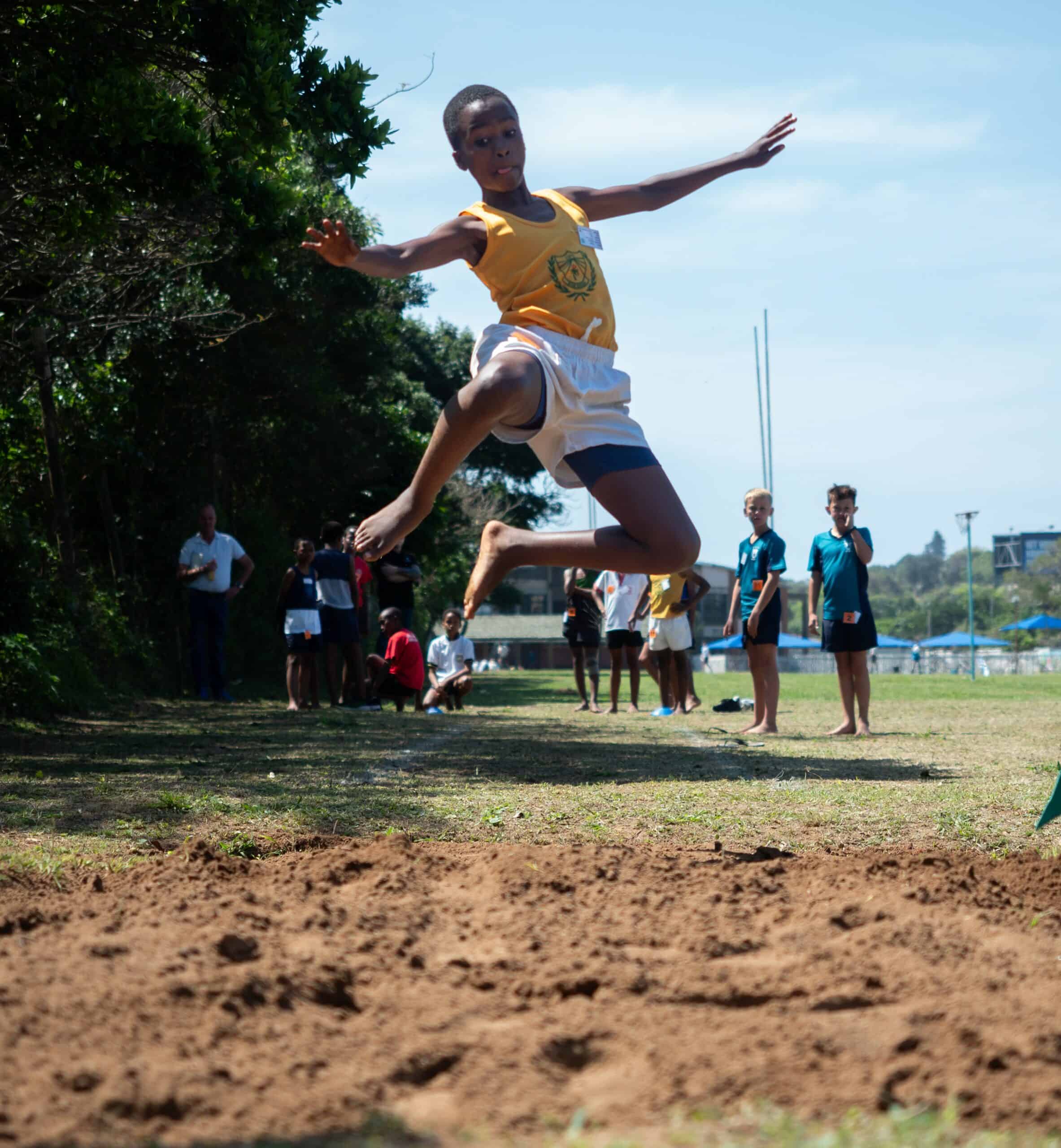 A child doing long jump.