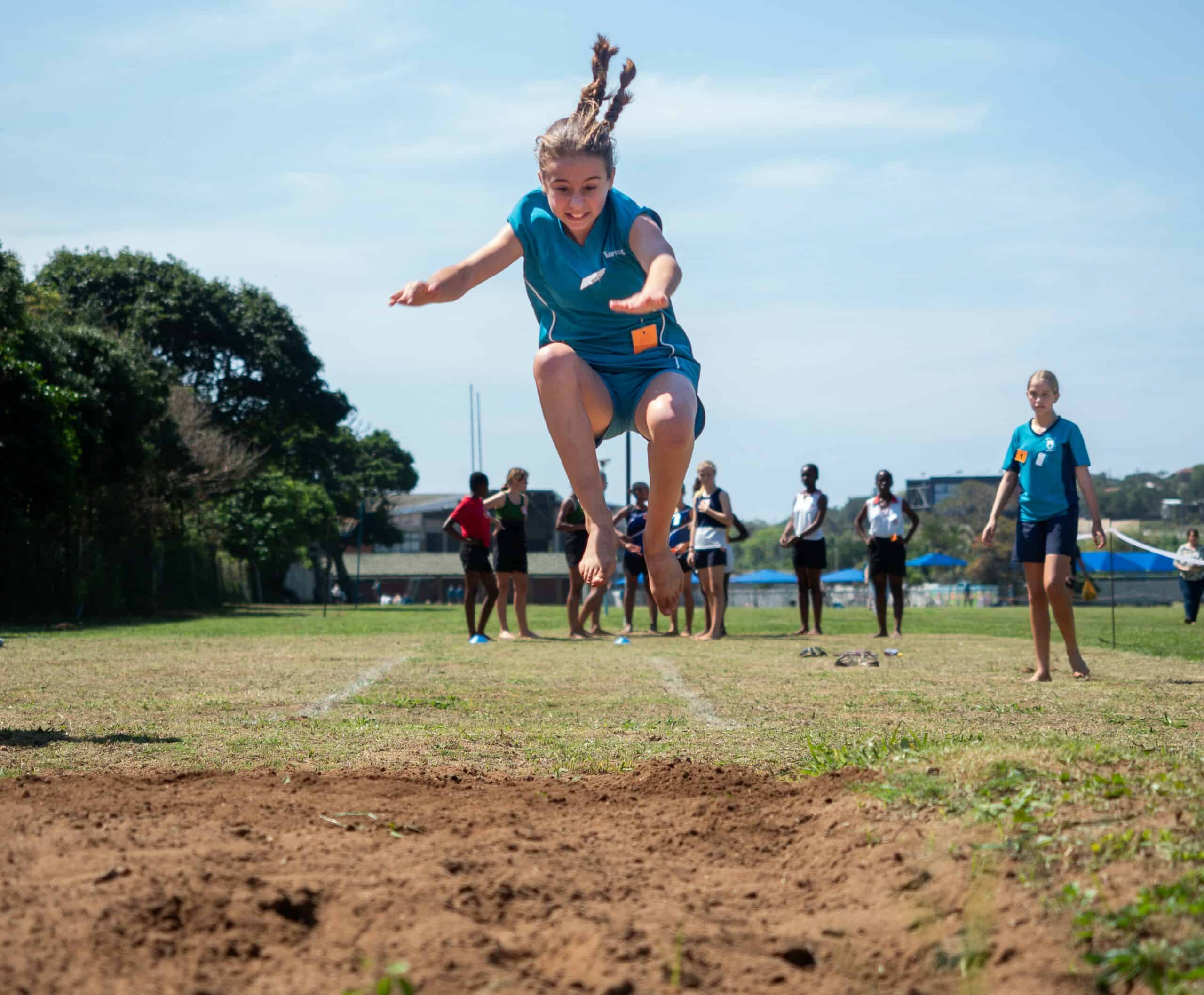 A child doing long jump.